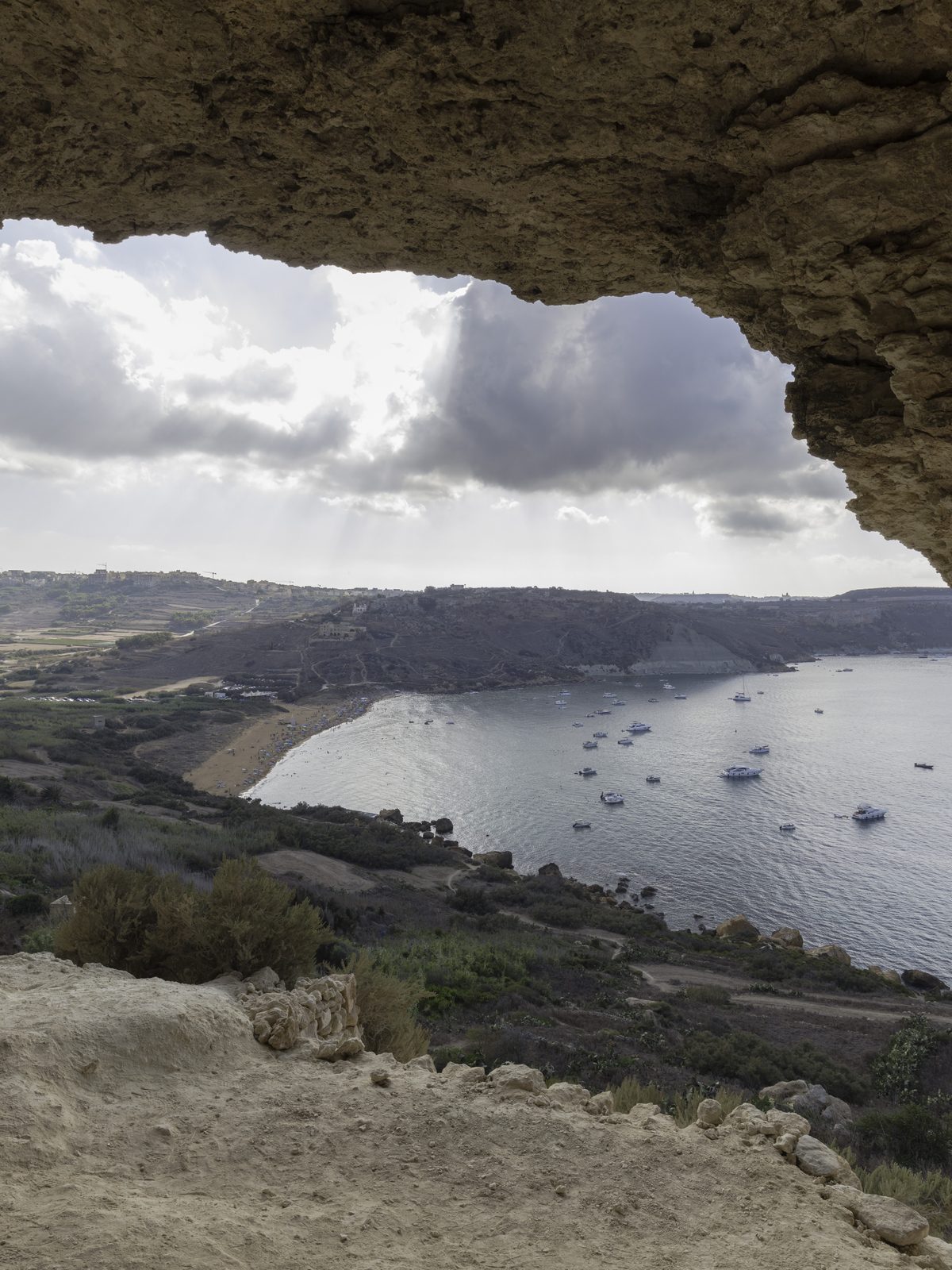 Ramla Bay on Gozo framed by the mouth of a cave